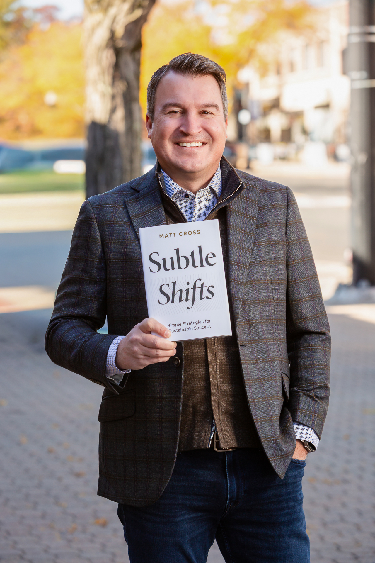 Matt Cross holding his book Subtle Shifts.
