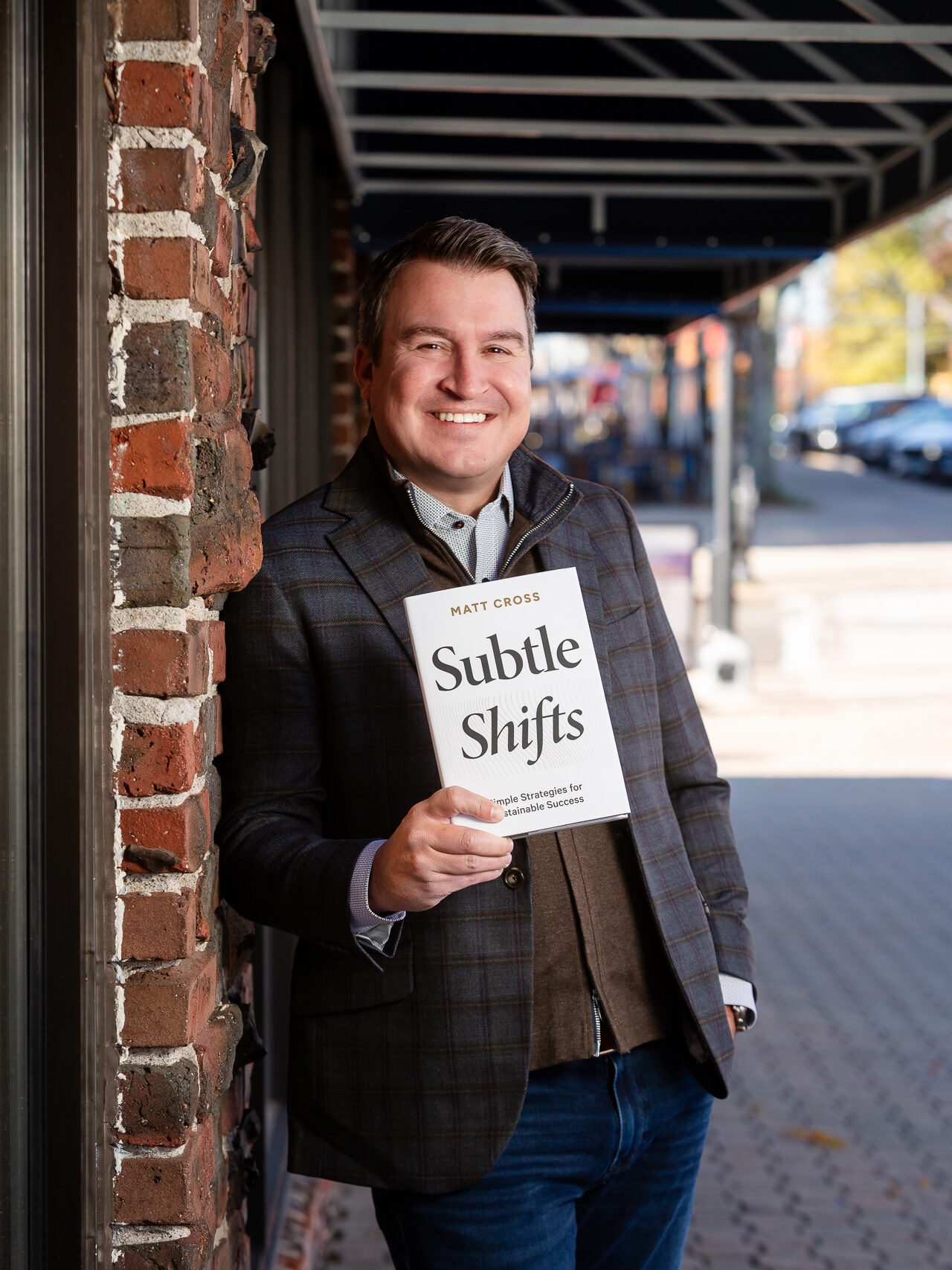 Matt Cross holding his book Subtle Shifts